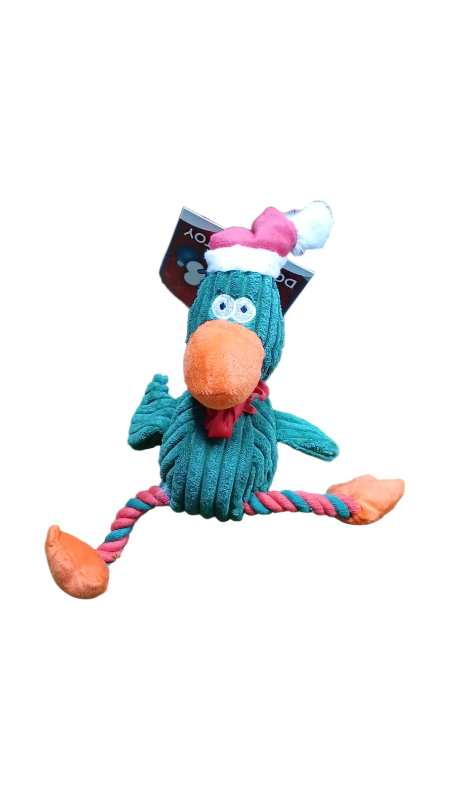 Toy duck with a red bow tie on a grassy surface with a wooden background