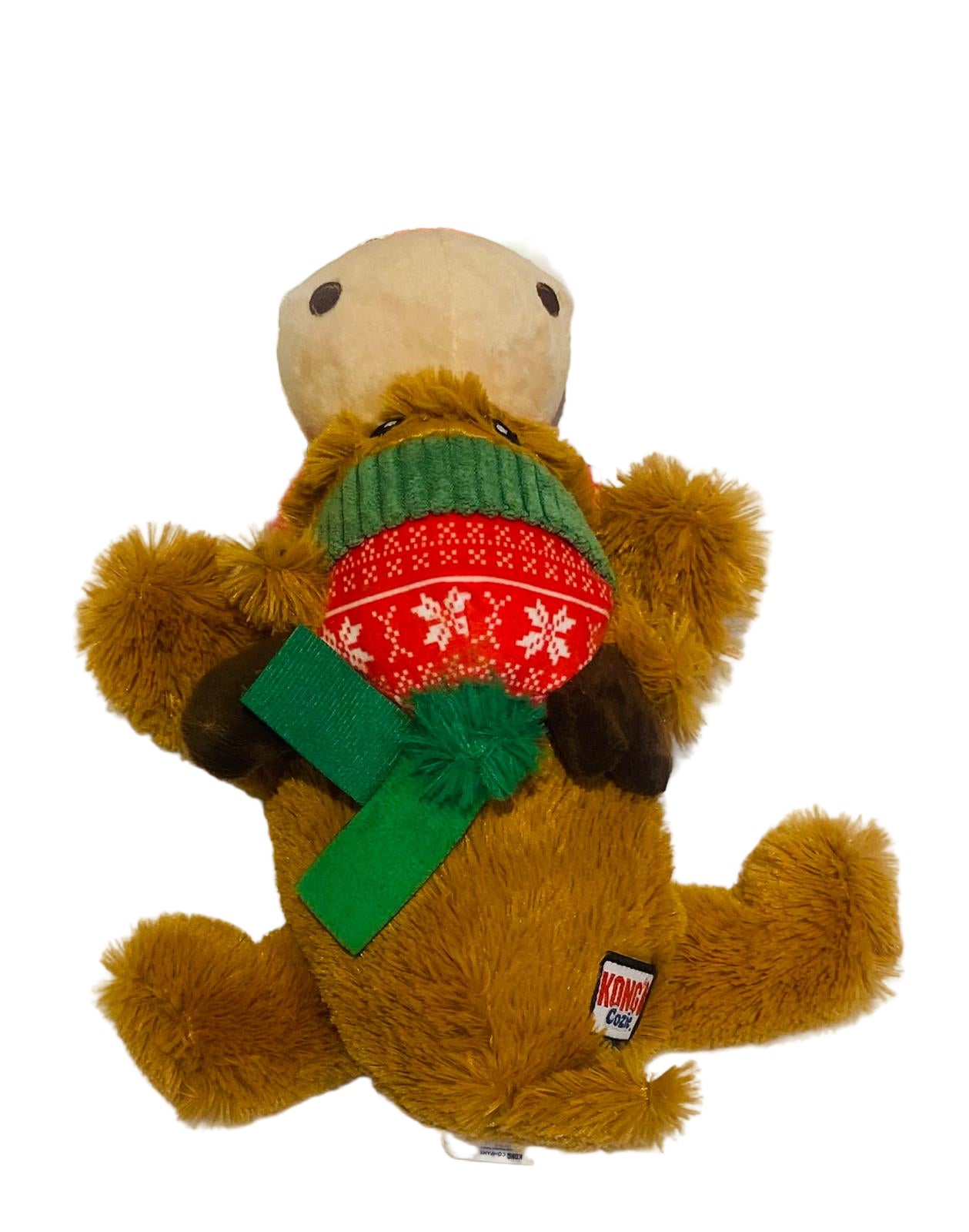 Plush dog toy with a green bow and red sweater on a white background