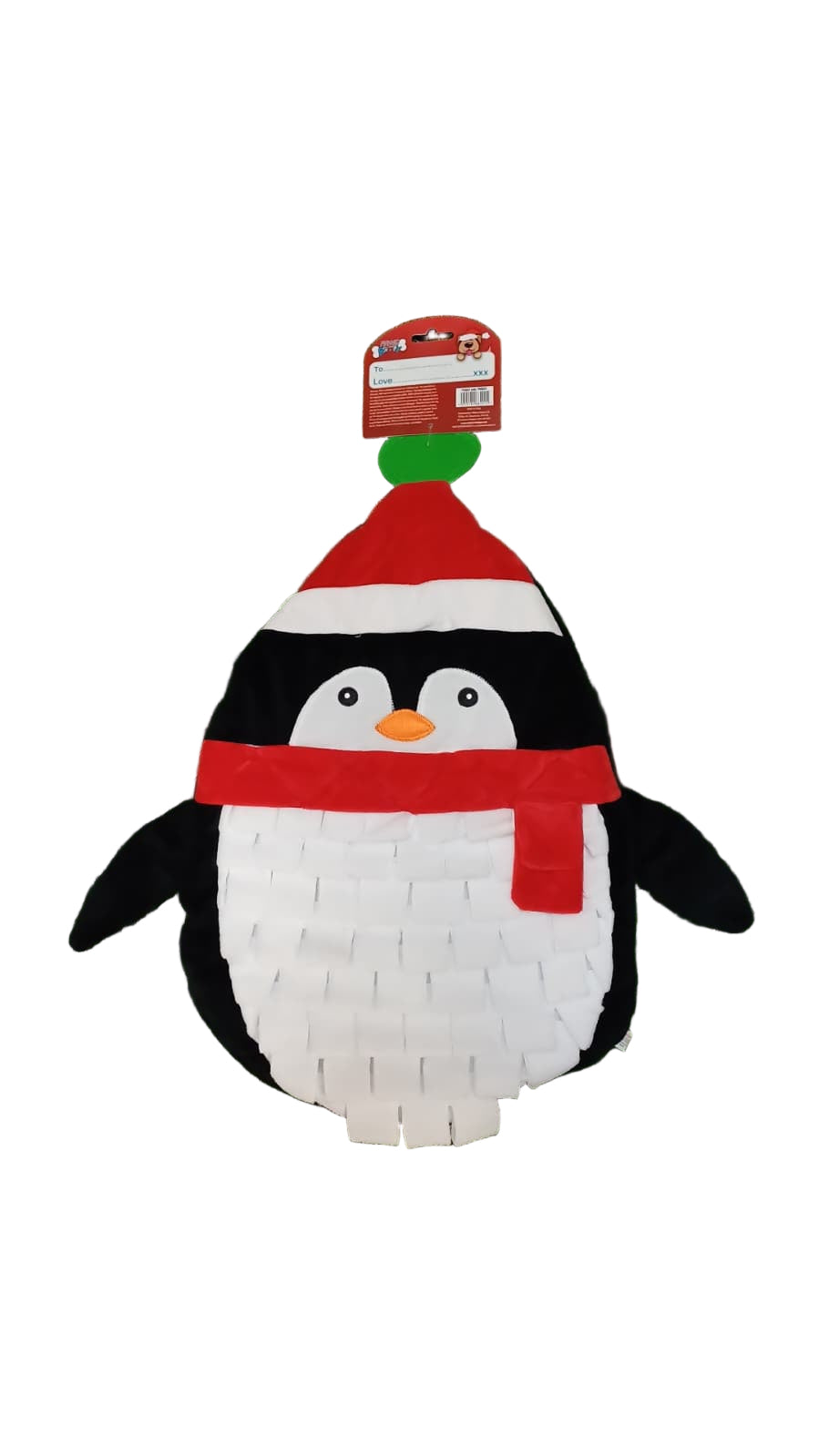 Penguin-shaped pinata with a red scarf and hat on a green surface