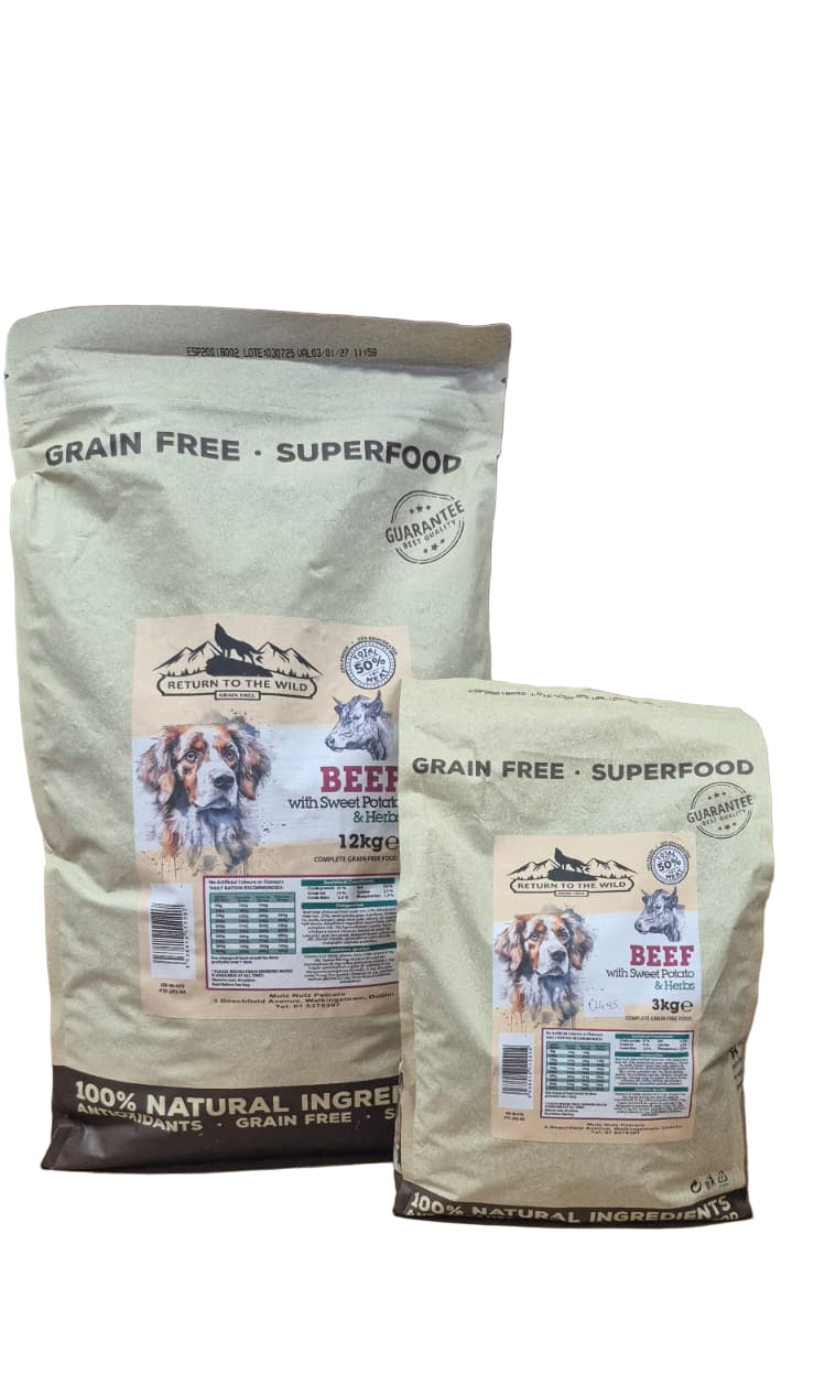 Two bags of grain-free beef superfood dog food on a table with a neutral background.