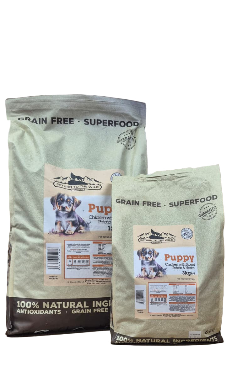 Two packages of grain-free puppy food on a brown surface.