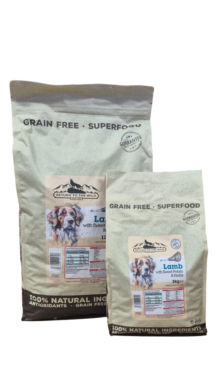 Two bags of grain-free dog food on a wooden surface with a purple background