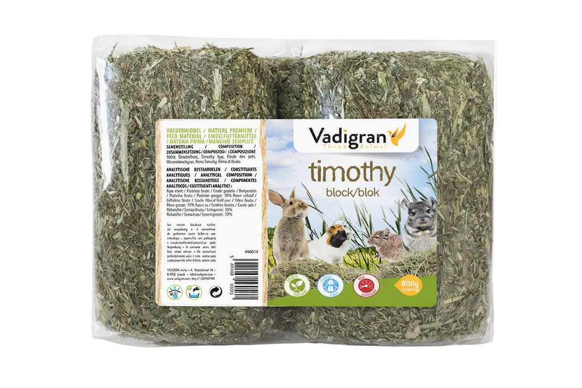 A package of Vadigran Timothy Hay Blocks for small animals, containing two blocks of dried grass in a clear plastic bag with a white and green label showing a rabbit and a hamster.